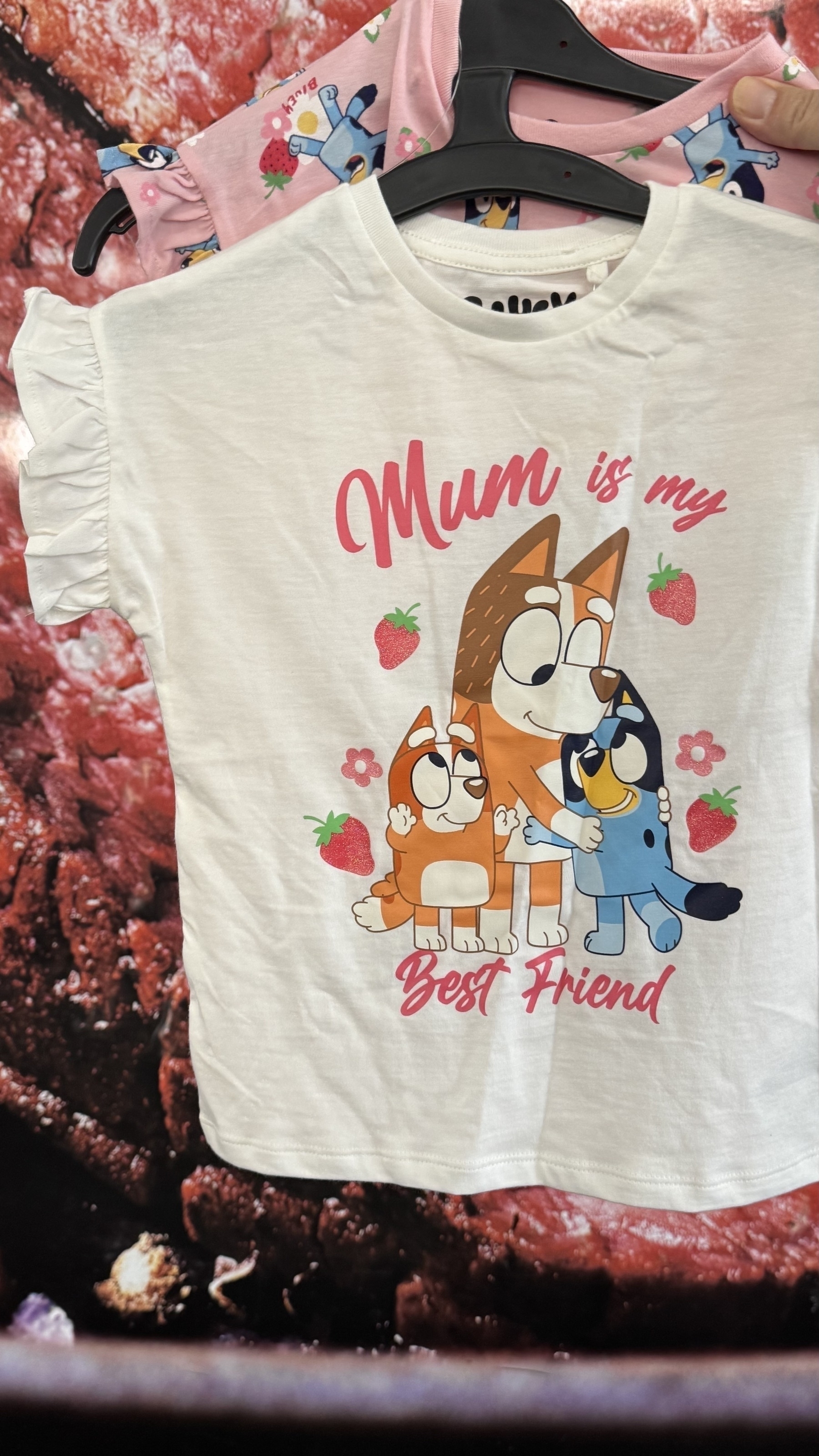 White shirt with Bluey and Bingo characters, reading "Mum is my Best Friend," hangs on a hanger.