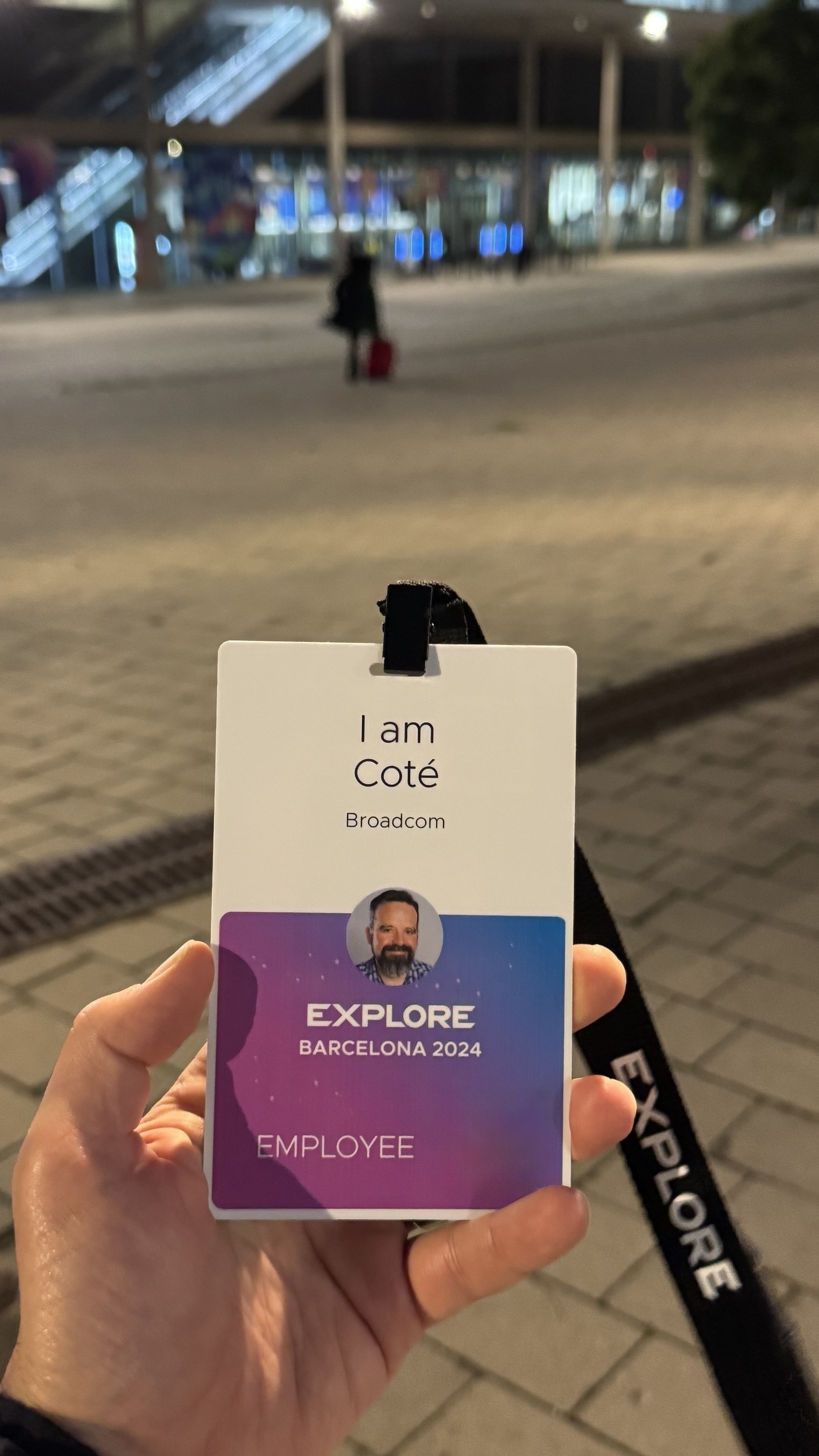 A lanyard with a Barcelona 2024 Explore badge featuring the name Coté is visible.