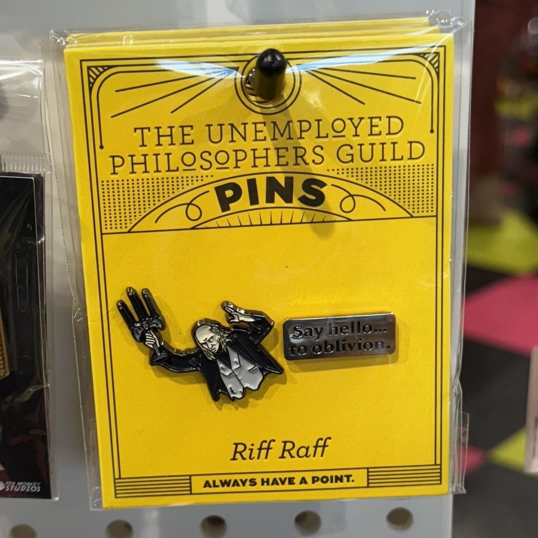 A yellow pin depicting Riff Raff from The Unemployed Philosophers Guild, with the text "ALWAYS HAVE A POINT.
