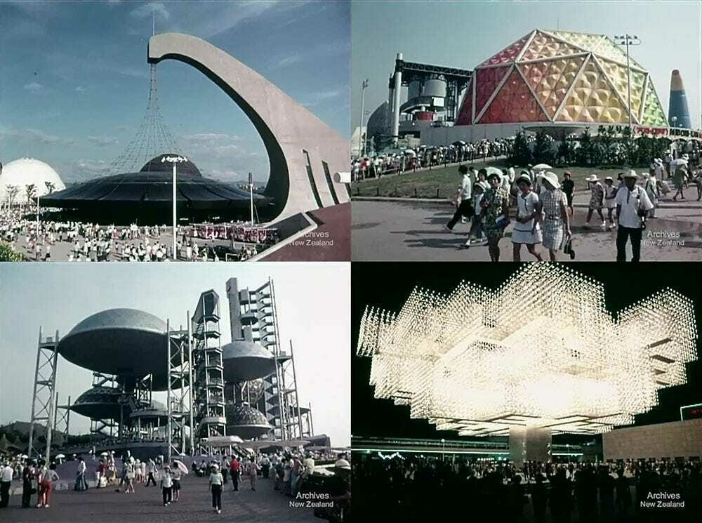 A crowd gathers around a futuristic, white, geodesic dome structure in a stadium setting.
