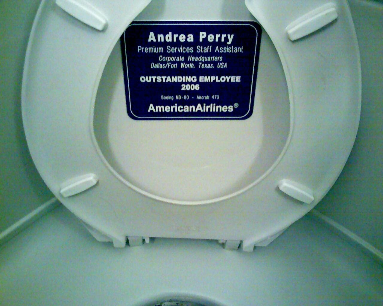 A white Boeing MD-80 airplane interior panel displays the text "Dallas/Fort Worth, Texas, USA".