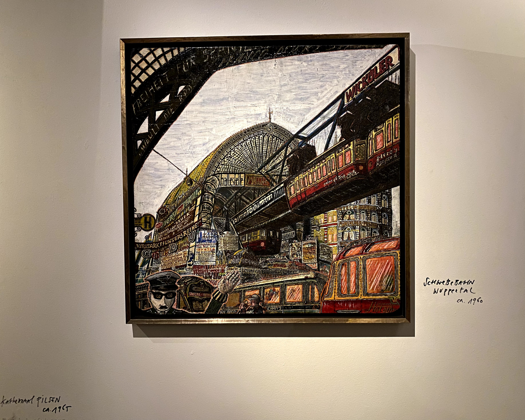 A painted work depicts a red subway train moving through a busy urban scene with text reading "FREIHEIT DIE WIR WIR".