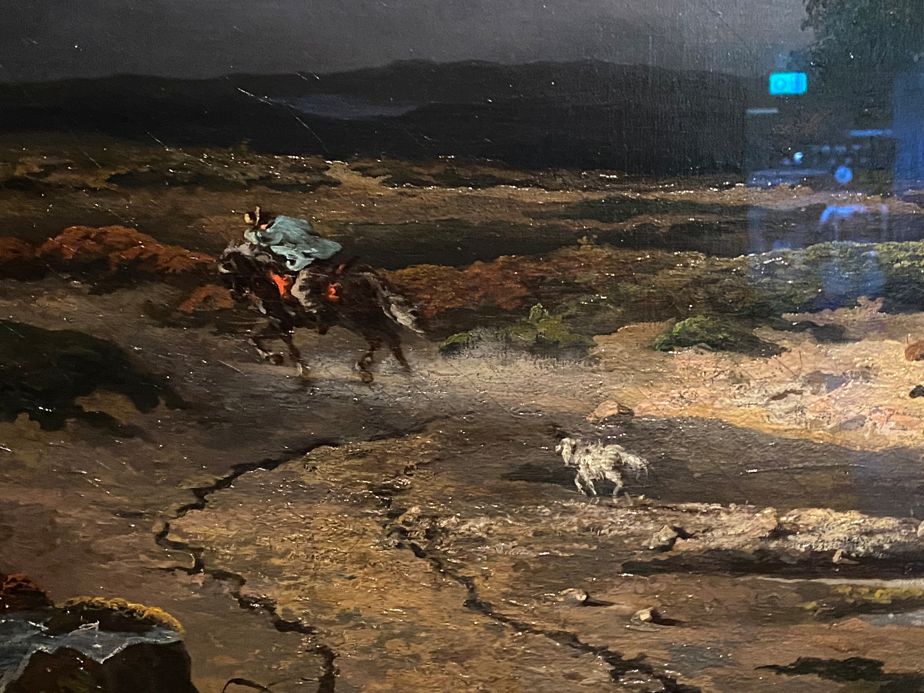 A dark-clad cowboy rides a horse through a muddy landscape, with the words “1878” visible in the upper right corner.